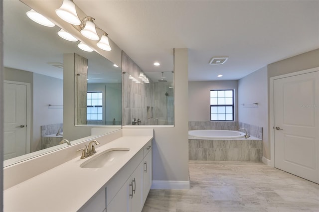 full bathroom featuring a garden tub, visible vents, a tile shower, vanity, and baseboards