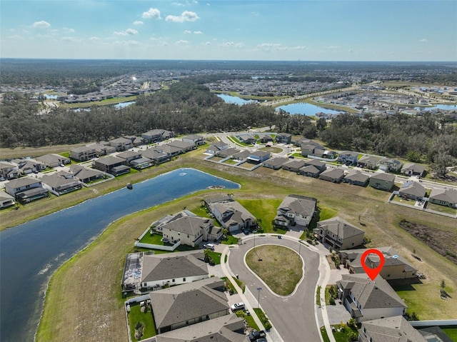 drone / aerial view featuring a residential view and a water view