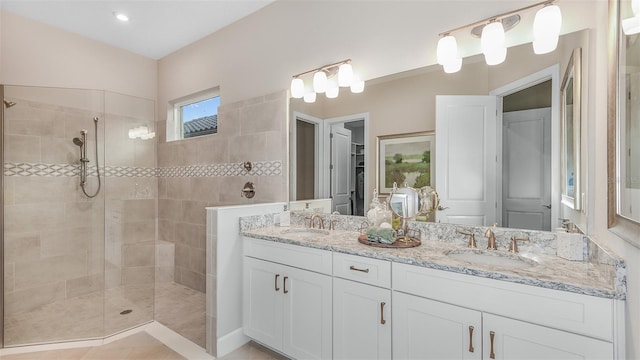 bathroom with vanity and a tile shower