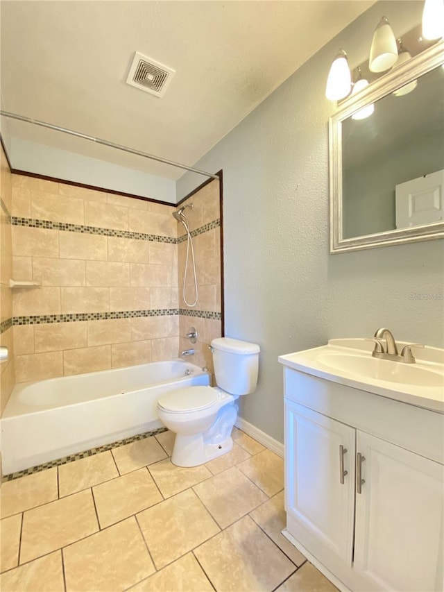 full bathroom with tiled shower / bath, vanity, toilet, and tile patterned flooring