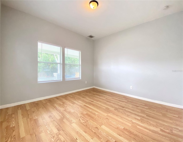 unfurnished room with light hardwood / wood-style floors