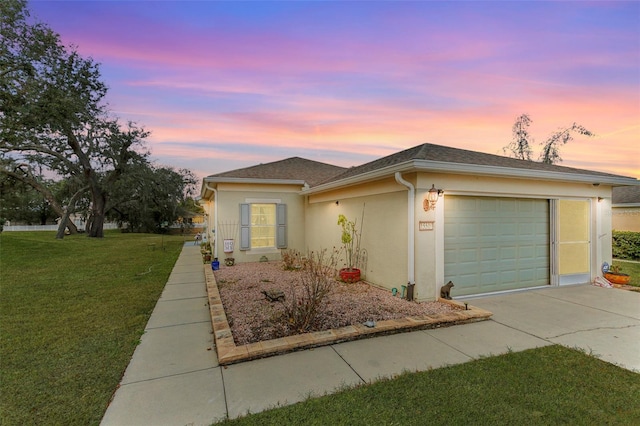 view of front of home featuring a garage and a lawn