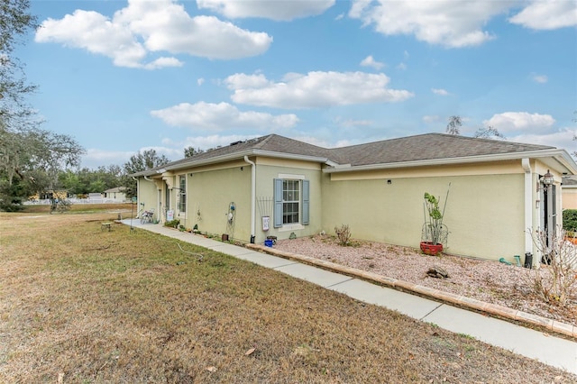 view of side of home with a yard