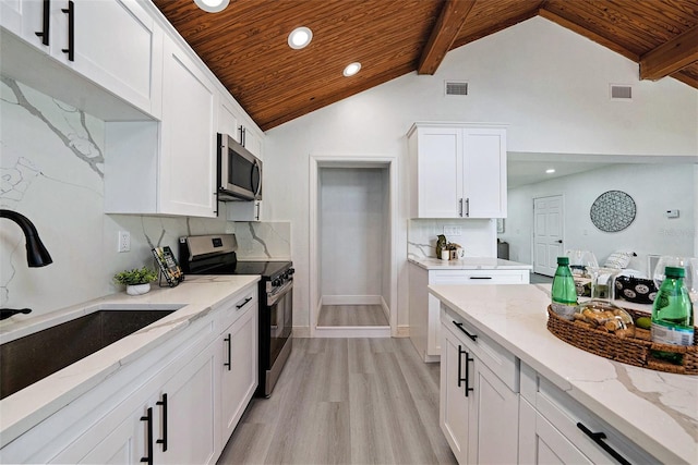 kitchen with stainless steel appliances, wooden ceiling, visible vents, and a sink