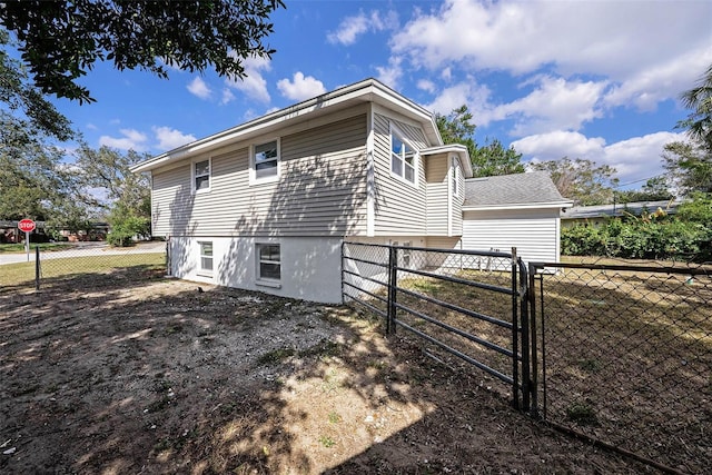 view of property exterior with a gate and fence