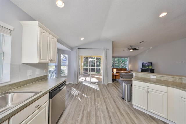 kitchen featuring lofted ceiling, sink, dishwasher, light hardwood / wood-style floors, and white cabinets