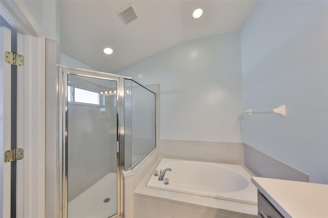 bathroom with vanity, lofted ceiling, and separate shower and tub