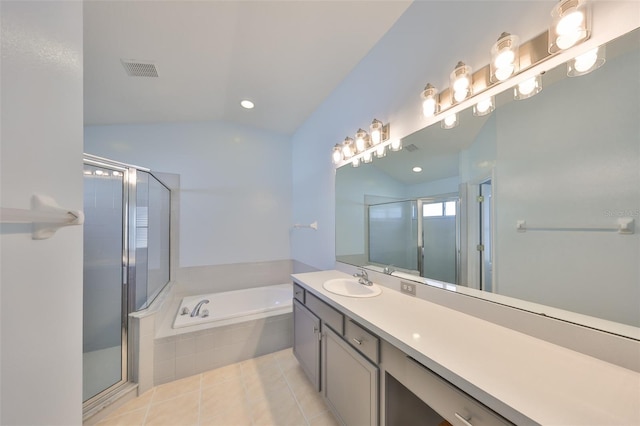 bathroom with tile patterned floors, lofted ceiling, separate shower and tub, and vanity