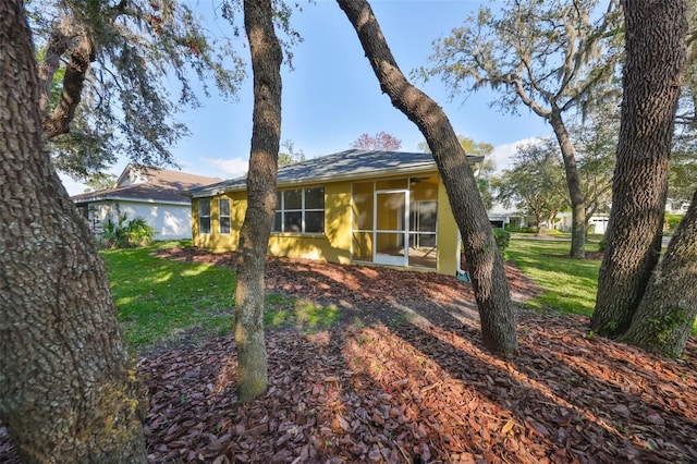 ranch-style house with a sunroom and a front lawn