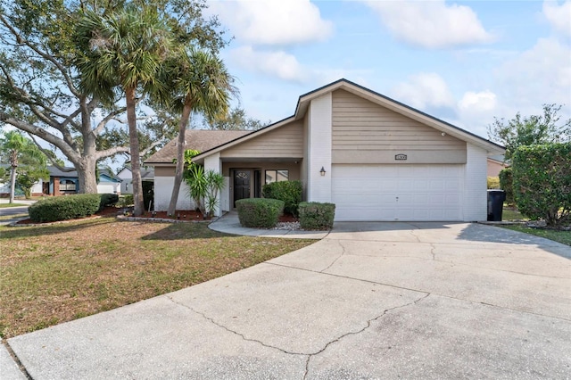 ranch-style home with a garage and a front yard