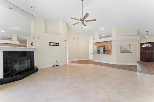 living room featuring high vaulted ceiling, a tile fireplace, and ceiling fan