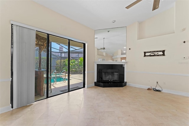 unfurnished living room with light tile patterned floors and ceiling fan