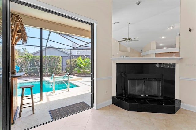 interior space featuring ceiling fan and a fireplace