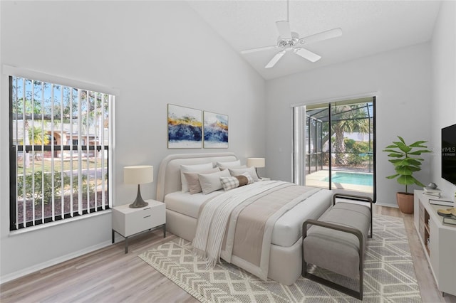 bedroom featuring high vaulted ceiling, light wood-type flooring, access to exterior, ceiling fan, and a textured ceiling