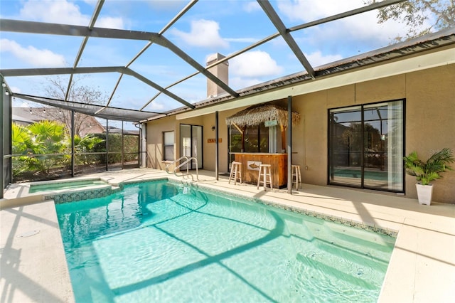 view of swimming pool with an in ground hot tub, a lanai, an outdoor bar, and a patio