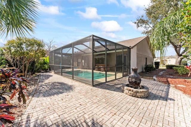 view of swimming pool featuring an outdoor fire pit and a patio area