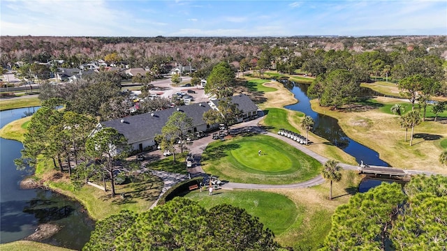 drone / aerial view with a water view and view of golf course