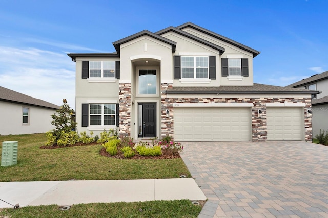 view of front of property with a garage and a front lawn