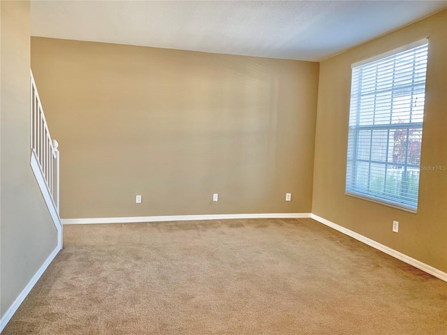 spare room with light colored carpet