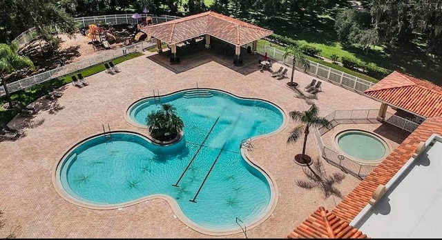 view of swimming pool with a hot tub, a gazebo, and a patio area