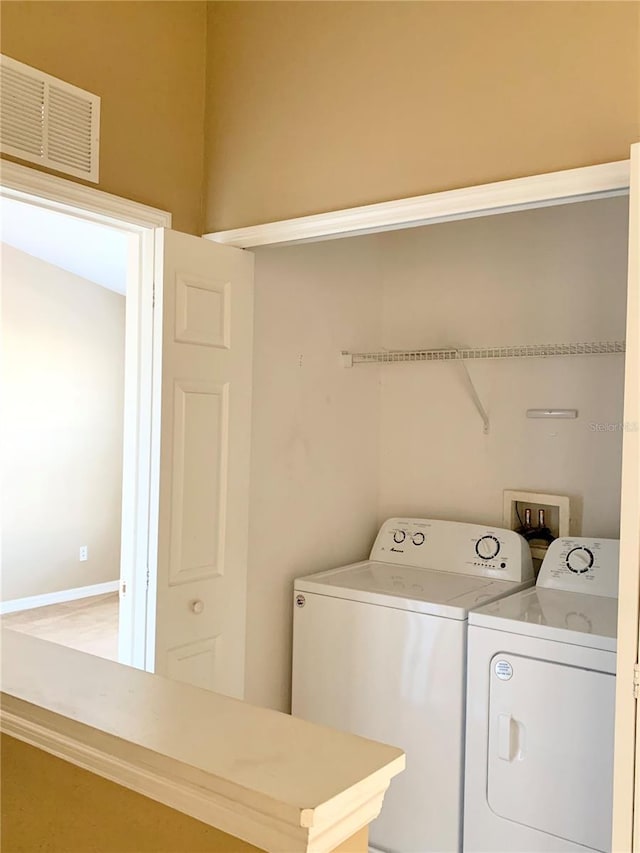 clothes washing area featuring washing machine and dryer