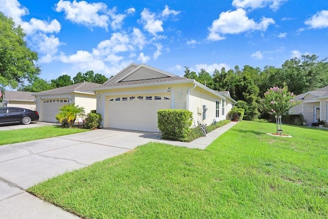 ranch-style house with a garage and a front lawn