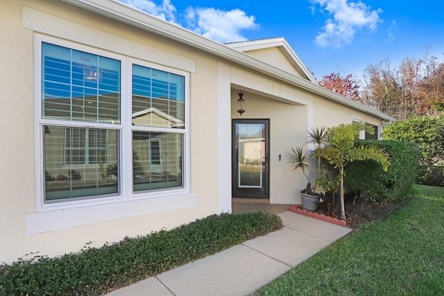 doorway to property with a yard