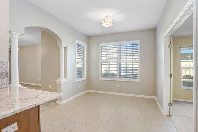 tiled dining space with decorative columns