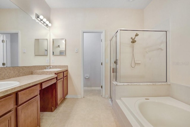 bathroom featuring plus walk in shower, vanity, and tile patterned floors