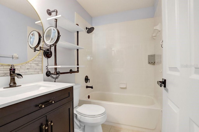 full bathroom featuring tiled shower / bath combo, vanity, tile patterned floors, and toilet