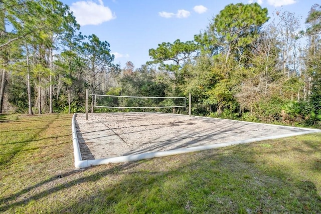 view of home's community with a lawn and volleyball court