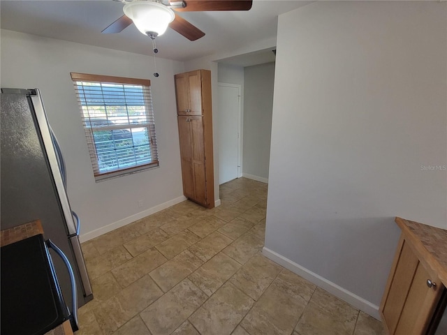 kitchen featuring ceiling fan and stainless steel refrigerator