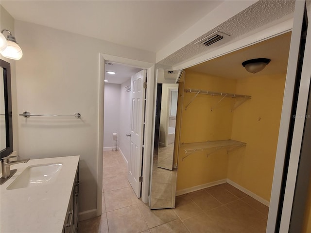 bathroom with vanity and tile patterned floors