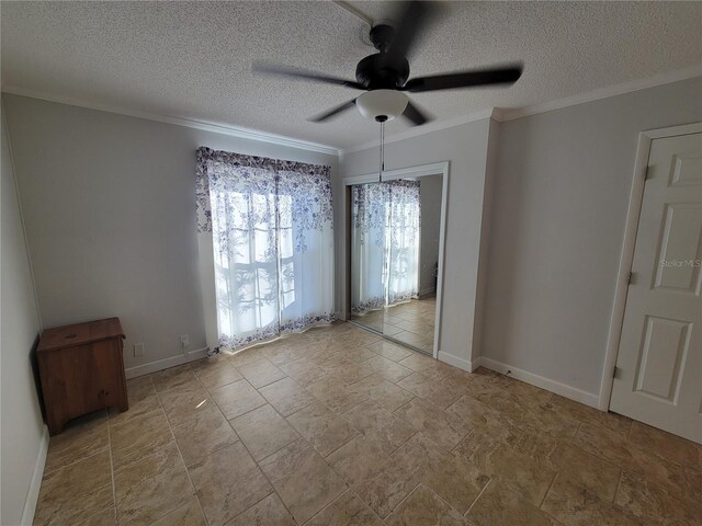 unfurnished room featuring ceiling fan, ornamental molding, and a textured ceiling