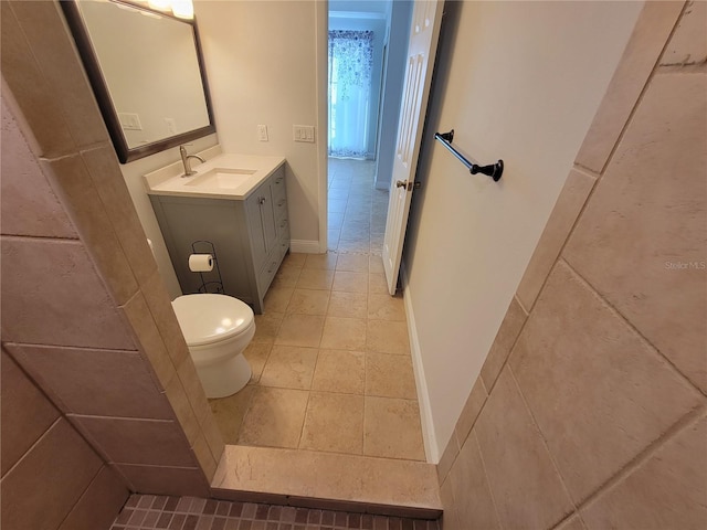 bathroom with vanity, tile patterned floors, and toilet