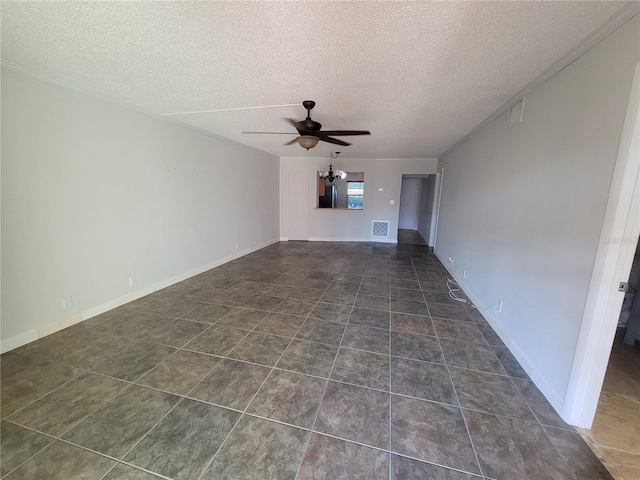 unfurnished living room featuring ceiling fan with notable chandelier, dark tile patterned floors, and a textured ceiling