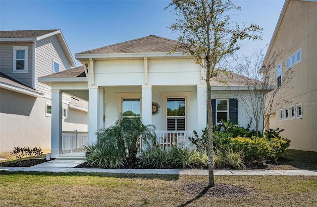 811 Winterside Dr, Apollo Beach, FL 33572 - view of front facade featuring a porch, roof with shingles, and stucco siding