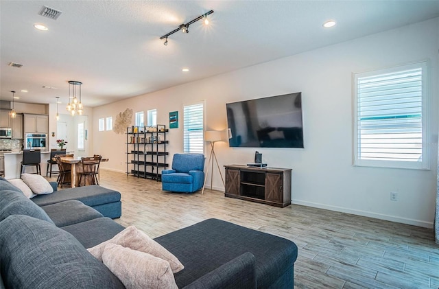 811 Winterside Dr, Apollo Beach, FL 33572 - living area featuring light wood-style flooring, rail lighting, recessed lighting, and a chandelier