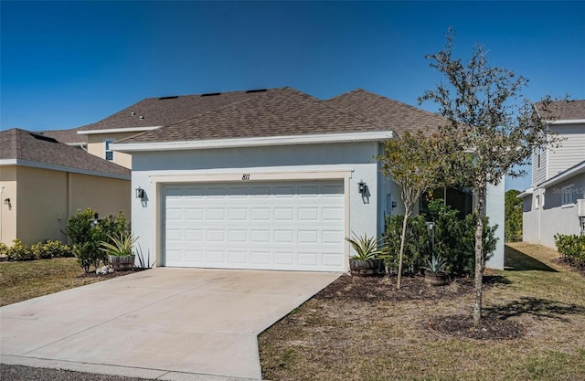 811 Winterside Dr, Apollo Beach, FL 33572 - view of front of house featuring roof with shingles, an attached garage, stucco siding, and driveway