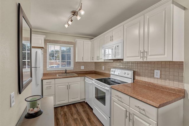 kitchen with white cabinetry, sink, dark wood-type flooring, and white appliances