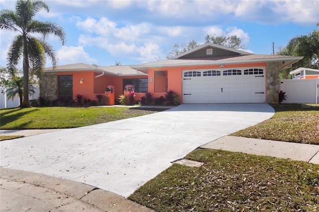 ranch-style house featuring a garage and a front yard