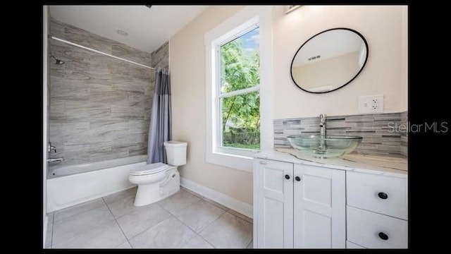 full bathroom featuring tile patterned floors, toilet, shower / tub combo, vanity, and backsplash