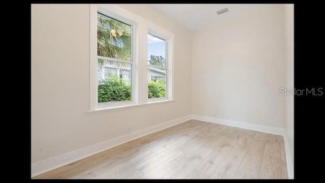 unfurnished room with light wood-type flooring