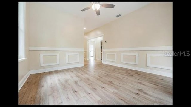 empty room with ceiling fan and light hardwood / wood-style floors