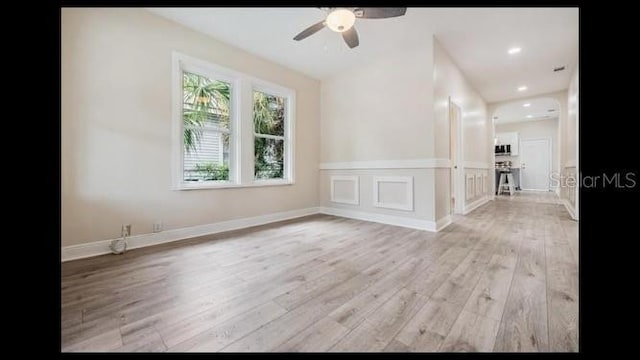 spare room featuring ceiling fan and light wood-type flooring