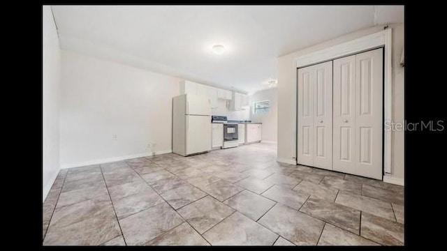 interior space featuring white appliances and white cabinets