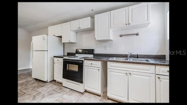 kitchen with range with electric cooktop, white refrigerator, sink, and white cabinets