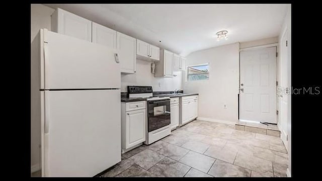 kitchen with white cabinets, white fridge, and electric range