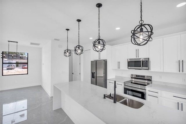 kitchen with sink, pendant lighting, stainless steel appliances, light stone countertops, and white cabinets