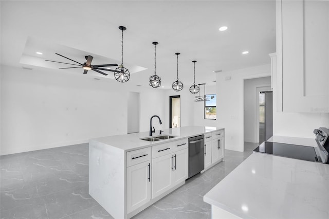 kitchen featuring an island with sink, appliances with stainless steel finishes, sink, and white cabinets